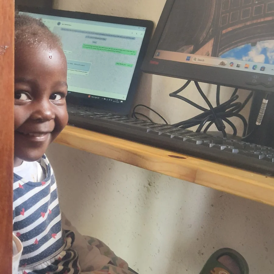 Child smiling with laptop